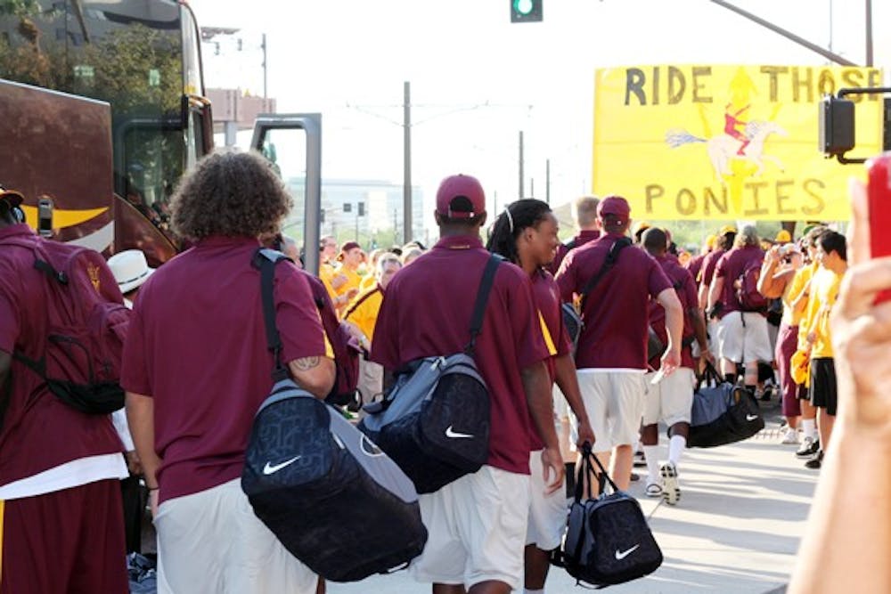 ON THE MOVE: The ASU football team departs from the buses and head towards Sun Devil Stadium during Friday’s traditional pregame “Devil Walk”. The Sun Devils will travel to Champagne, Ill. to face the Fighting Illini of Illinois on Saturday. (Photo by Beth Easterbrook).