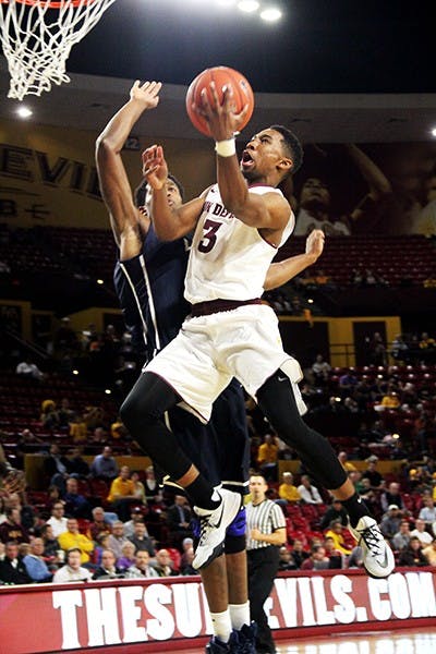 Sophomore guard Chance Murray battles a Loyola Marymount defender to the net at a home game on Thursday, Nov. 20, 2014. The Sun Devils won against Loyola Marymount 68–44. (Photo by Sawyer Hardebeck)