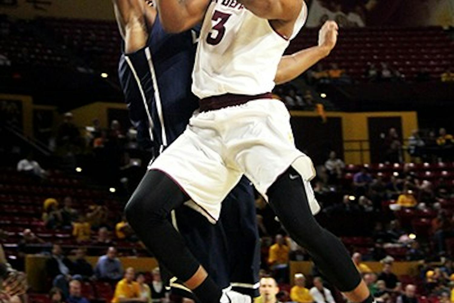 Sophomore guard Chance Murray battles a Loyola Marymount defender to the net at a home game on Thursday, Nov. 20, 2014. The Sun Devils won against Loyola Marymount 68–44. (Photo by Sawyer Hardebeck)
