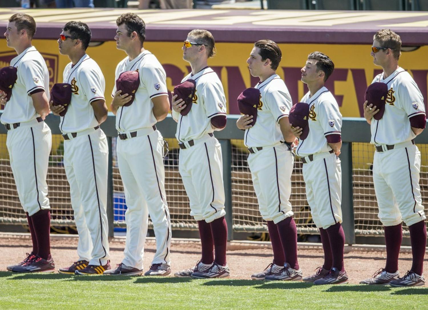 ASU baseball players remove their hats for the National Anthem before a game against California at Phoenix Municipal Stadium in Phoenix, Arizona, on Sunday, April 17, 2016. The Sun Devils won the final game in this series 4-0.