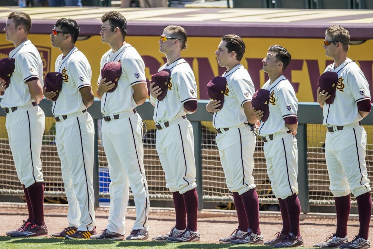 ASU baseball players remove their hats for the National Anthem before a game against California at Phoenix Municipal Stadium in Phoenix, Arizona, on Sunday, April 17, 2016. The Sun Devils won the final game in this series 4-0.