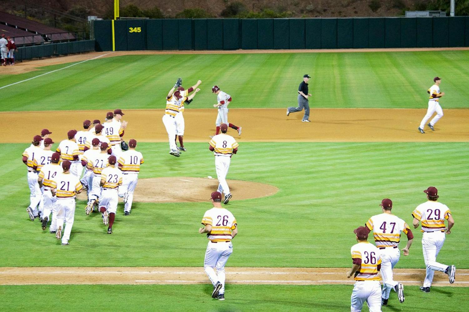 Sun Devils storm the field after their victory against Stanford, Saturday, March 28, 2015, at Phoenix Municipal Stadium. The Sun Devils defeated the Cardinal 6-3. (Krista Tillman/The State Press)