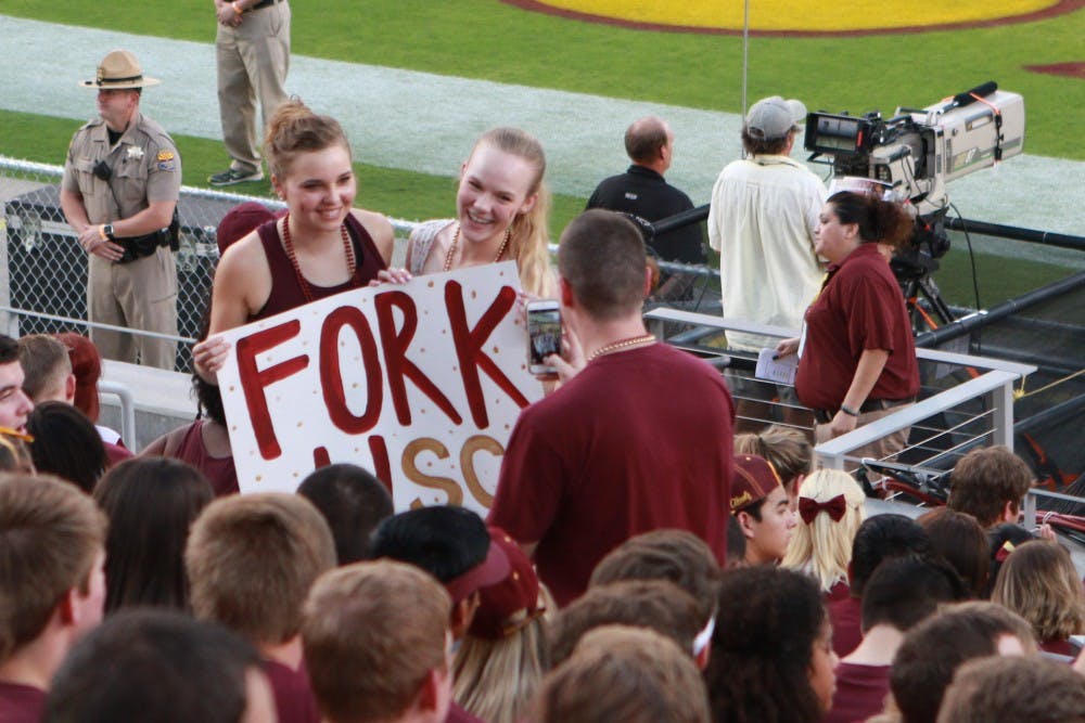 Students hold up a sign for a photograph before the game against University of Southern California Saturday, Sept. 26, 2015 at Sun Devil Stadium in Tempe. 
