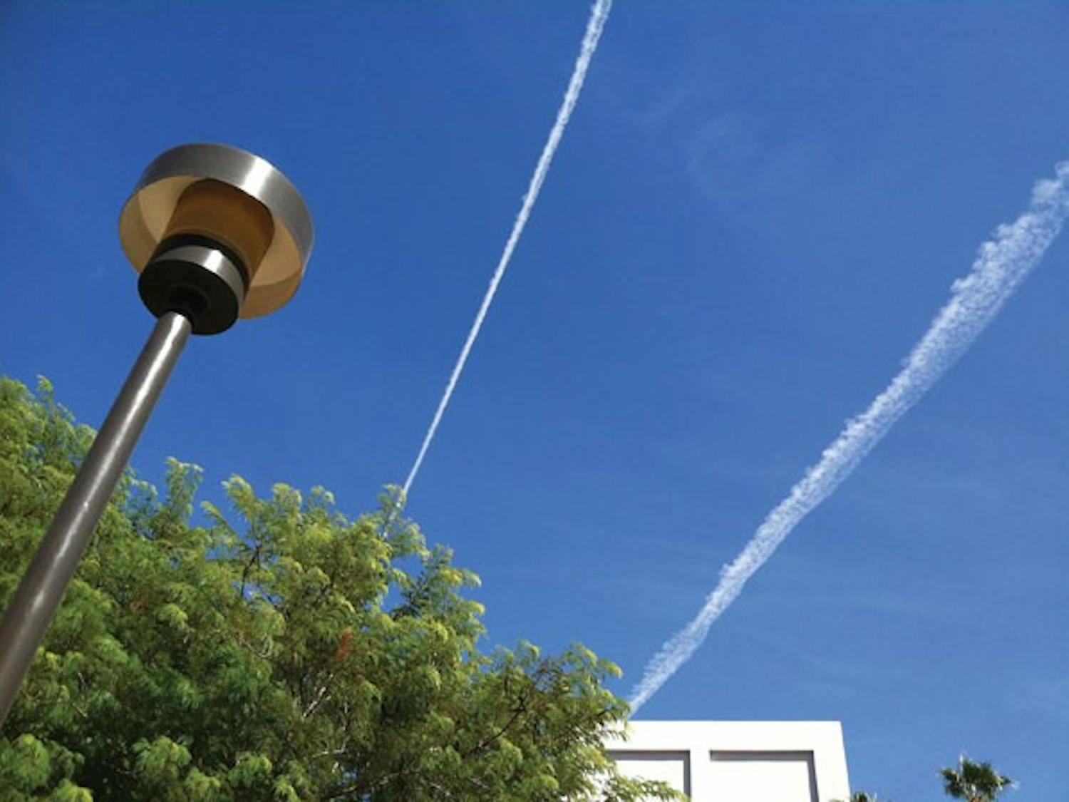 Contrails streak the blue sky on a warm fall afternoon. (Photo by Robin Kiyutelluk)