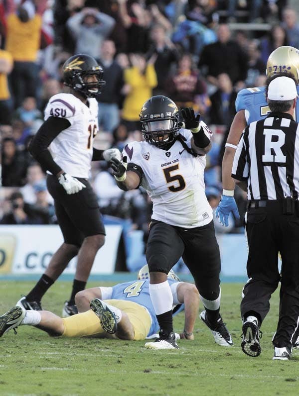 Junior defensive end Junior Onyeali celebrates after a play during a road game against UCLA last Nov. Onyeali will begin the season as a playing defensive end after playing last year as a linebacker.  (Photo by Beth Easterbrook)
