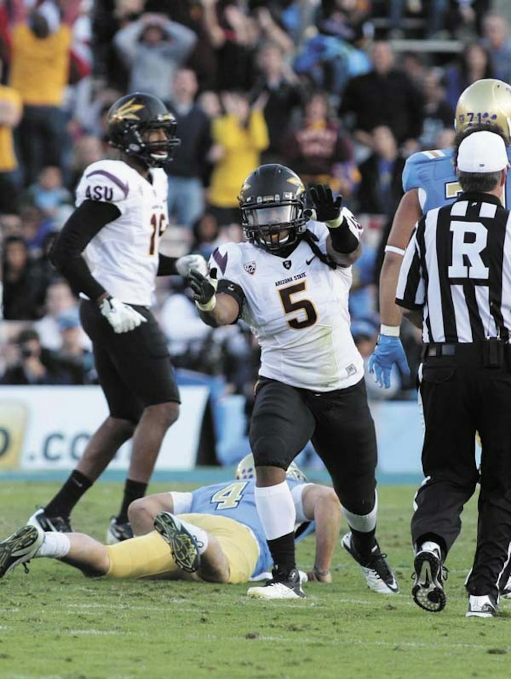 Junior defensive end Junior Onyeali celebrates after a play during a road game against UCLA last Nov. Onyeali will begin the season as a playing defensive end after playing last year as a linebacker.  (Photo by Beth Easterbrook)
