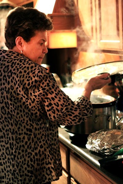 Lucy Berchini, Administative Associate for SHArCS (School of Humanities, Arts and Cultural Studies) for the West Campus, checks on the food one last time before serving for the 2013 Gumbo Challenge. (Photo by Ashley Kesweder)