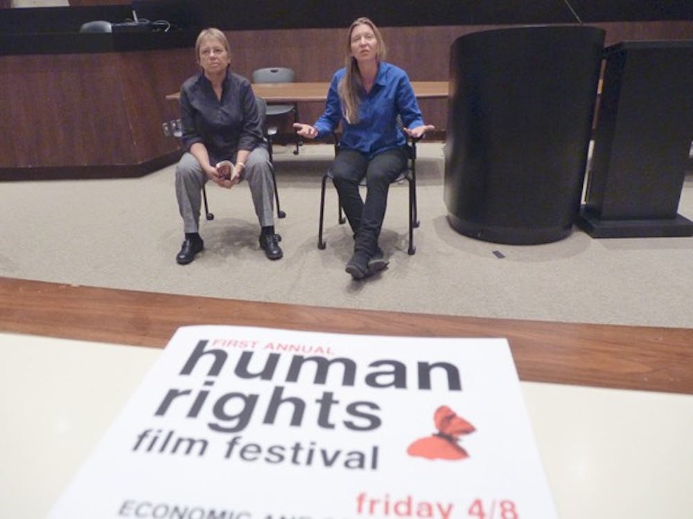 RAISING AWARENESS: Mary Margaret Fonow, women and gender studies professor and director of the School of Social Transformation, and LaDawn Haglund, assistant professor of Justice and Social Inquiry and director of the undergraduate certificate in human rights, discuss the documentary "The Economics of Happiness" with an audience of about 120 after watching the film at the inaugural Human Rights Film Festival Friday night.  (Photo by Harmony Huskinson)