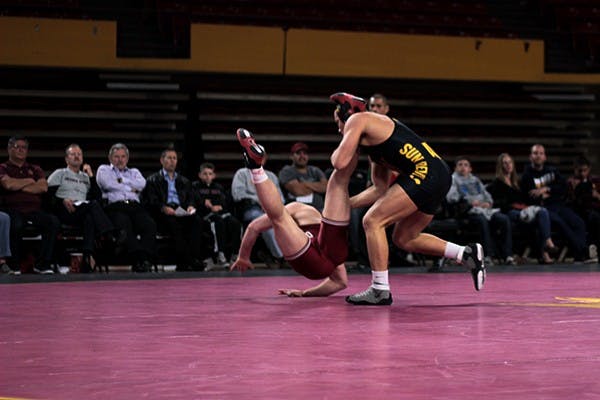 In a match against Boise State on Friday, Jan. 24, Preston McClamon attempts to wrangle his rival to the floor. (Photo by Mario Mendez)