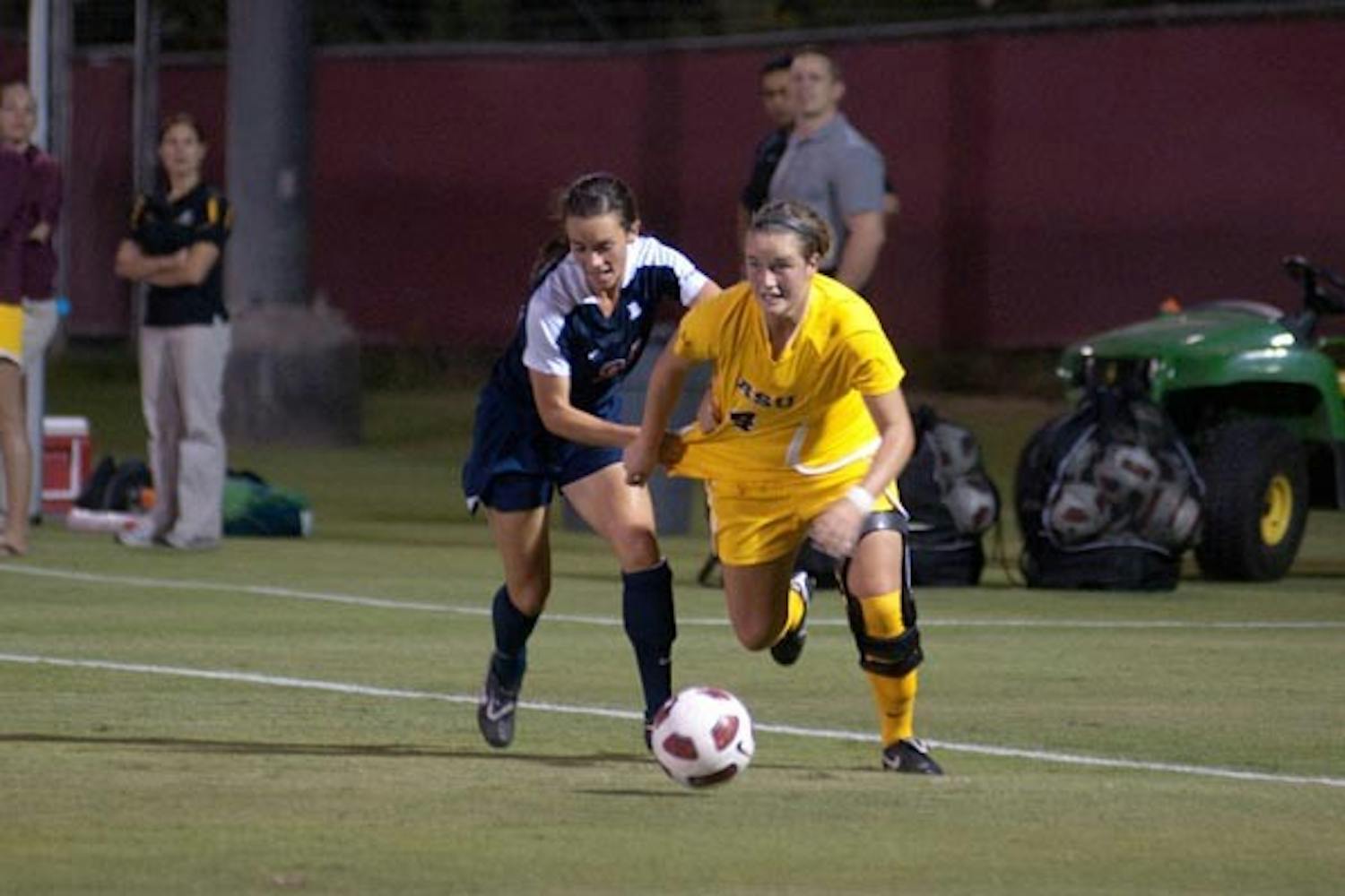 ESCAPE ARTIST: Senior midfielder/forward Jill Shoquist battles out of the grasp of a UA defender during last week’s 2-1 win. The ASU women’s soccer team takes on No. 1 Stanford on Friday and Cal on Sunday. (Photo by Aaron Lavinsky)