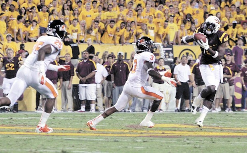 TAKING IT HOME: Junior wide receiver Jamal Miles looks to evade Oregon State junior safety Anthony Watkins during the Sun Devils’ 35-20 win over the Beavers on Oct. 1. A win over Colorado on Saturday will ensure ASU bowl eligibility for the first time since 2007. (Photo by Beth Easterbrook)