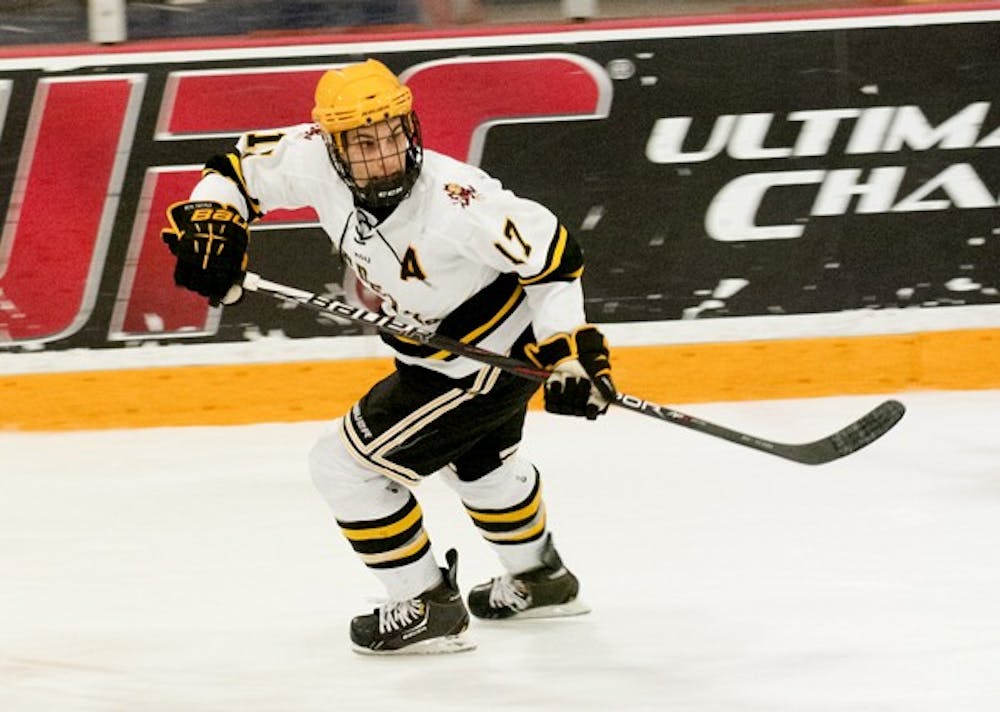 Junior forward Kale Dolinski flashes down the ice looking for a pass from his teammate against UA on Feb. 2. Dolinski is one of many players recruited from Canada to play for the club hockey team. (Photo by Molly J. Smith)