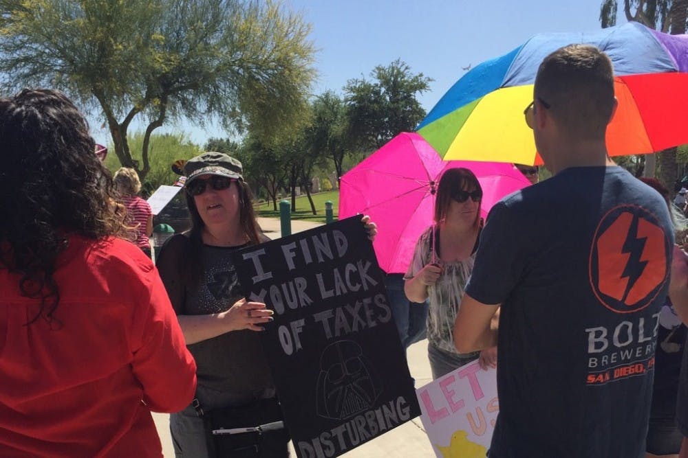 Protesters gather at the Arizona Capitol building in Phoenix, Arizona on April 15, 2017.
