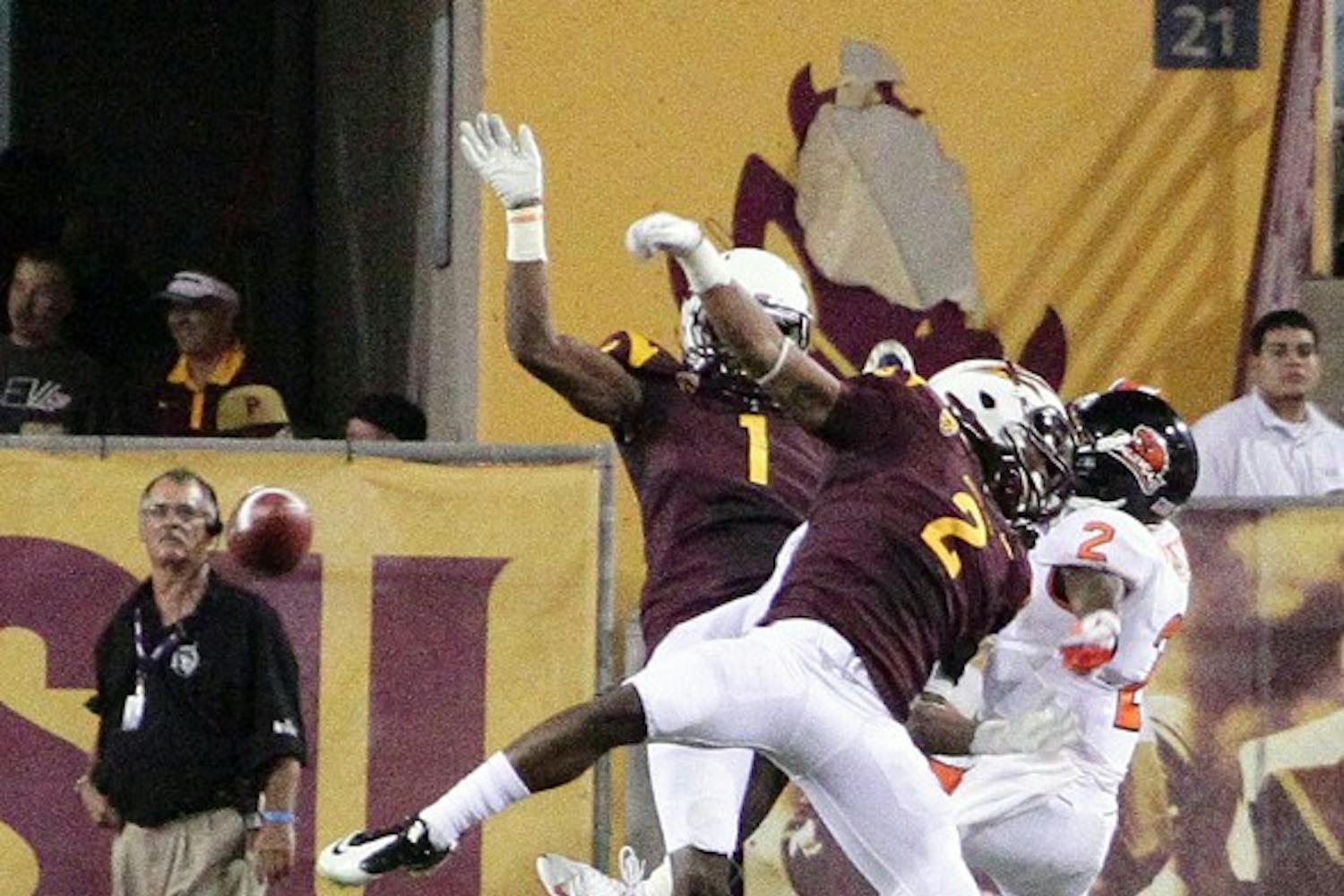 TALL ORDER: ASU corner backs Eddie Elder and Deveron Carr take down Oregon State junior wide receiver Markus Wheaton during the Sun Devils’ win over the Beavers on Sept. 1. Elder and Carr said defending against Oregon on Saturday will be tough, but the secondary is ready for the challenge. (Photo by Beth Easterbrook)