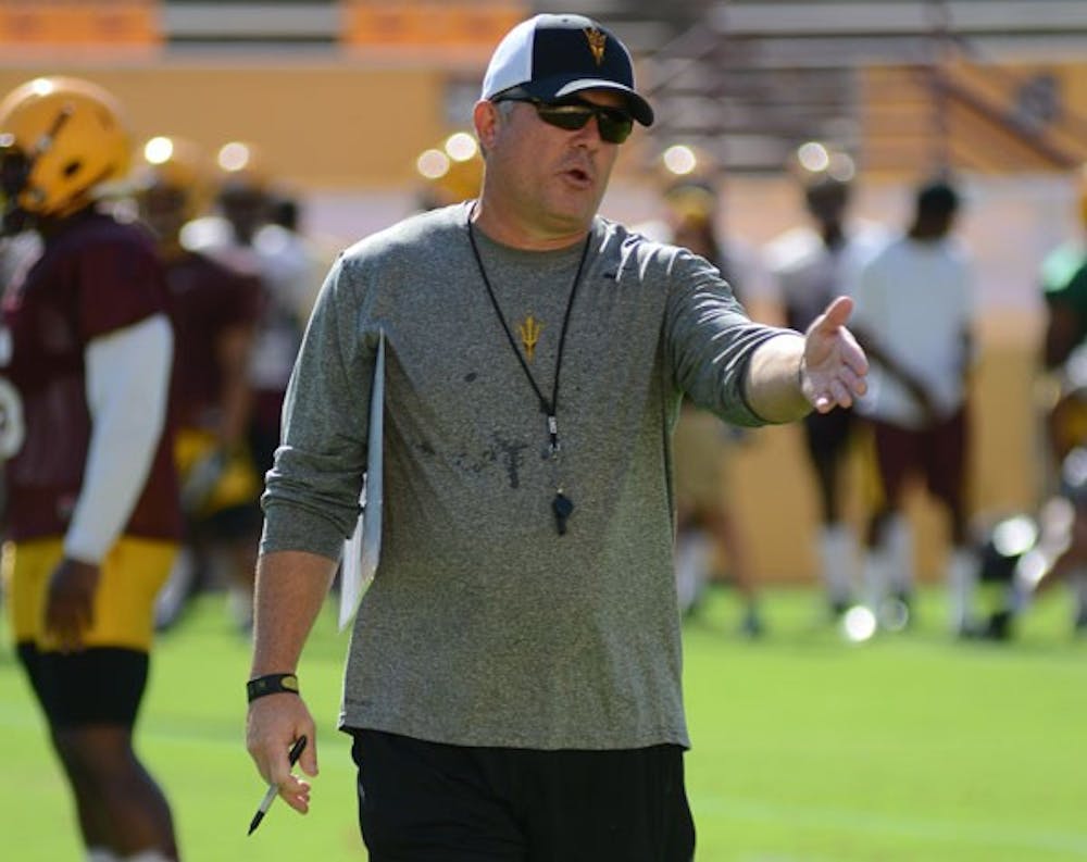 Coach Todd Graham talks with a player during the Sun Devils’s practice at Sun Devil Stadium on Tuesday. Graham will coach his first game at ASU in Thursday’s home game against NAU. (Photo by Aaron Lavinsky)
