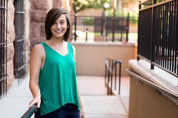 Elizabeth Whitton poses next to the Newman Center at University Drive and College Avenue in Tempe. Whitton decided to give up two years of her life to do missionary work at ASU. (Photo by Ryan Liu)