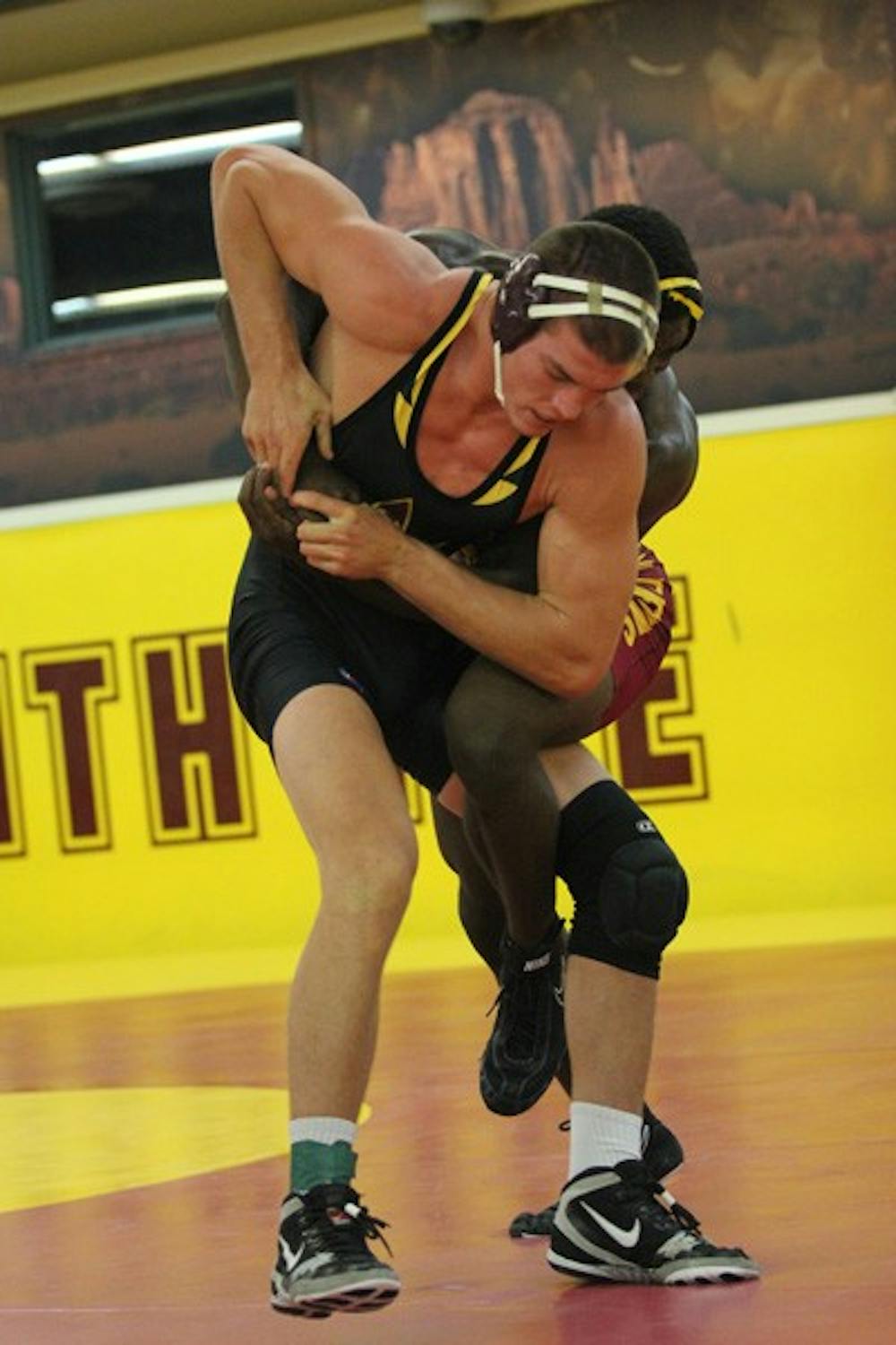 Redshirt senior Jake Meredith grapples with teammate and redshirt sophomore Kevin Radford in ASU’s annual Maroon vs. Gold match on Oct. 26. (Photo by Kyle Newman)