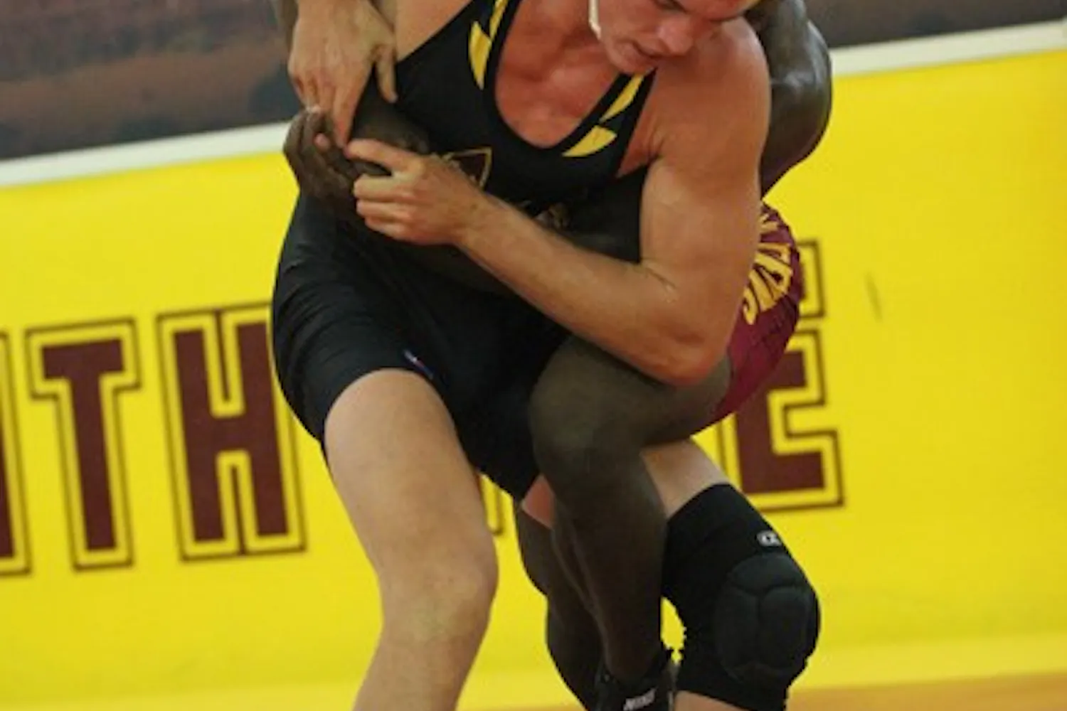 Redshirt senior Jake Meredith grapples with teammate and redshirt sophomore Kevin Radford in ASU’s annual Maroon vs. Gold match on Oct. 26. (Photo by Kyle Newman)