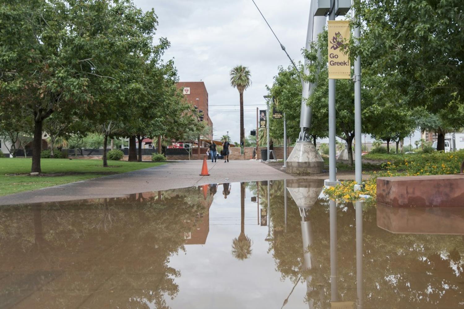Flooding is seen at a parking structure on Third Street near Mill Avenue in Tempe. The flooding was the result of a record-setting rainstorm in the Valley. (Photo by Ben Moffat)