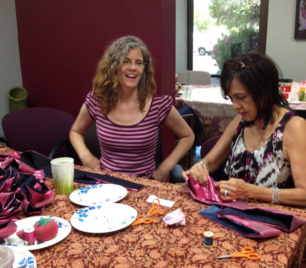 Crystal Daigle teaches Sharra, a community volunteer, how to make a Resiliency Rose. (Photo courtesy of Crystal Daigle)