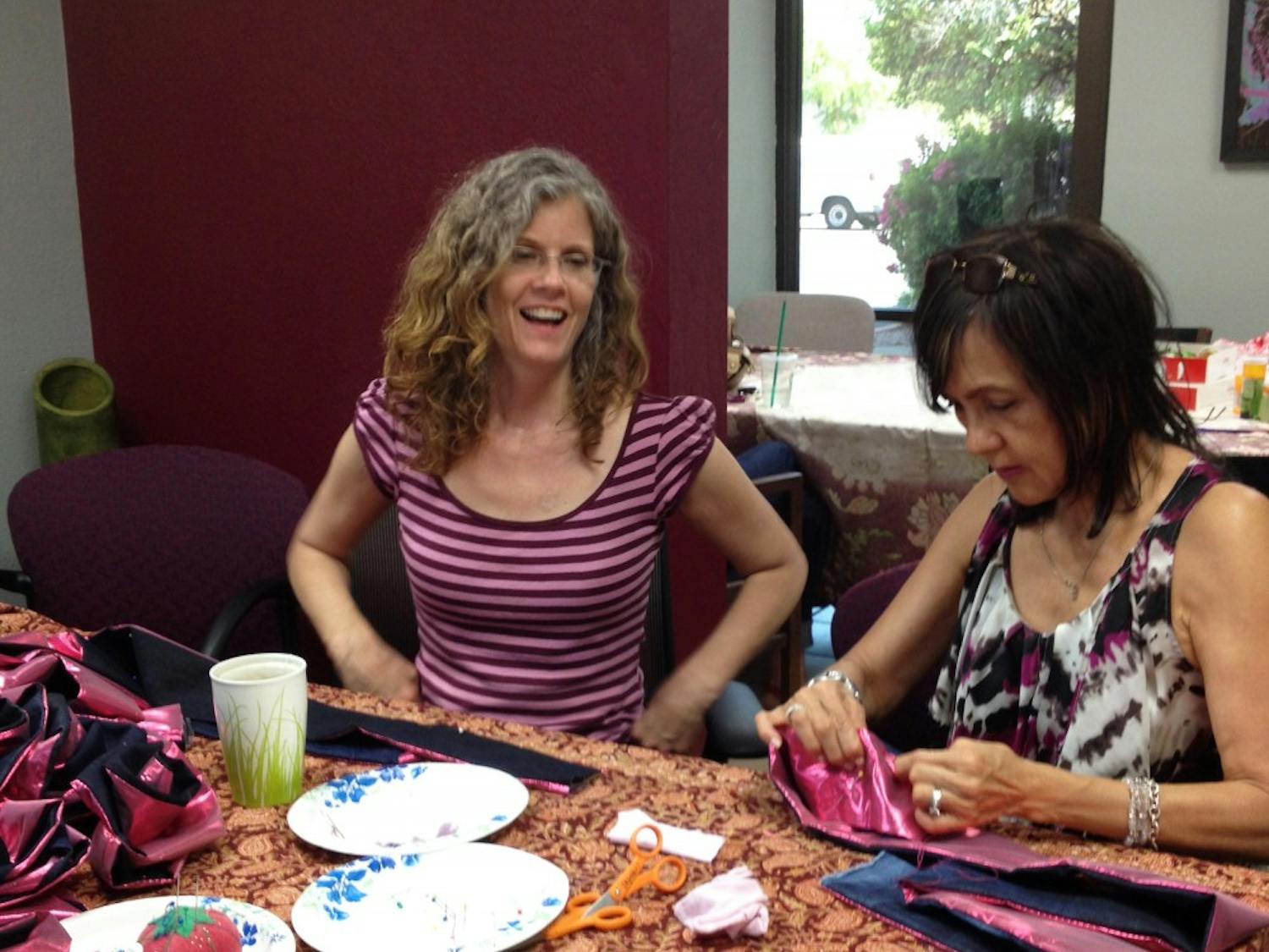 Crystal Daigle teaches Sharra, a community volunteer, how to make a Resiliency Rose. (Photo courtesy of Crystal Daigle)