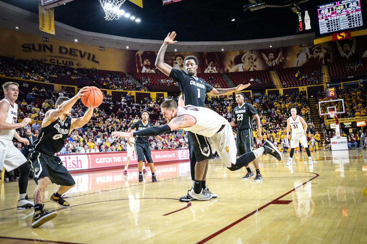 Junior Eric Jacobsen dives in an attempt to recover the rebound in a game against the Colorado Buffaloes on Saturday, Jan. 17, 2015 at Wells Fargo Arena in Tempe.