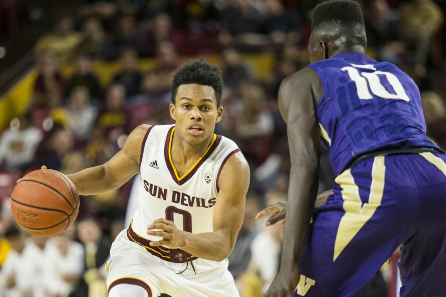 Arizona State Sun Devils guard Tra Holder (0) looks for an opening in the Husky defense during a game against the University of Washington Huskies in Wells Fargo Arena on Saturday, Jan. 16, 2015, in Tempe, Ariz. The Huskies won the matchup, 89-85.