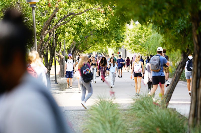 Students walk down East Lemon Mall outside the Sun Devil Fitness Complex on the ASU Tempe campus on Monday, Sept. 27, 2021.