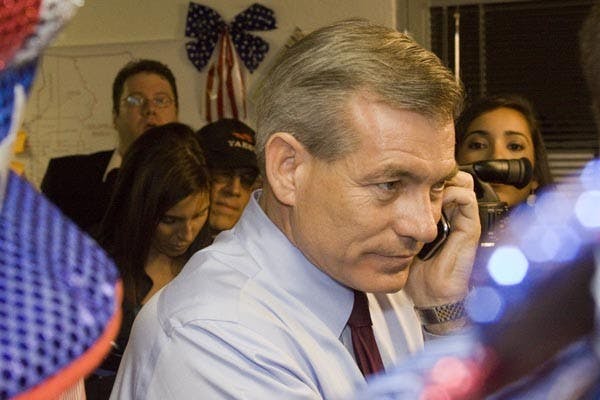 AND THE WINNER IS: David Shweikert uses his cell phone to try and get news of voting results after internet connections go down on Tuesday night. (Photo by Annie Wechter)