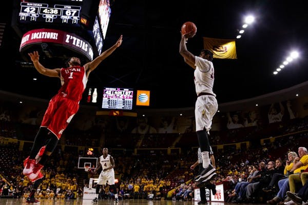 Junior forward Sai Tummala (right) shoots a three pointer over Utah freshman guard Isaiah Wright, Thursday, Jan. 15, 2015, at Wells Fargo Arena in Tempe. Tummala made the three, but the Sun Devils fell to the Utes 76-59. (Daniel Kwon/The State Press)