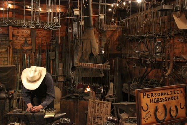 Devin Mace engraves a horseshoe in his blacksmith shop. (Photo by Kyle Newman)