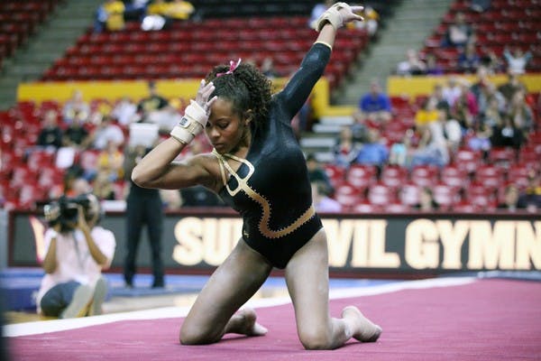 Beaté Jones holds a pose before she starts her floor routine on Sunday afternoon during the Gym Devils’ match against Illinois. (Photo by Beth Easterbrook)
