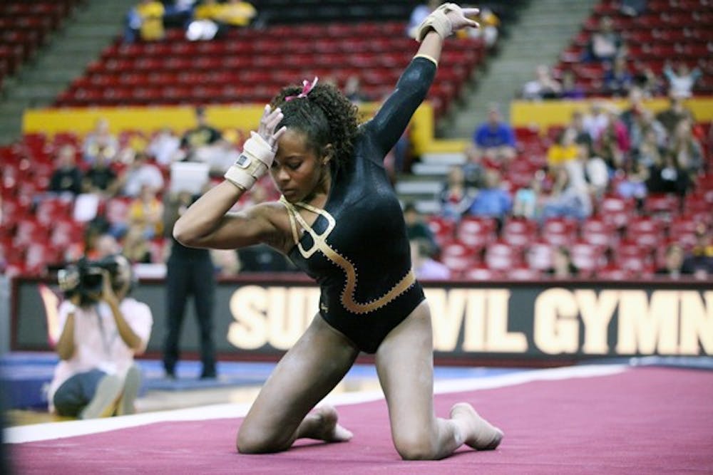 Beaté Jones holds a pose before she starts her floor routine on Sunday afternoon during the Gym Devils’ match against Illinois. (Photo by Beth Easterbrook)