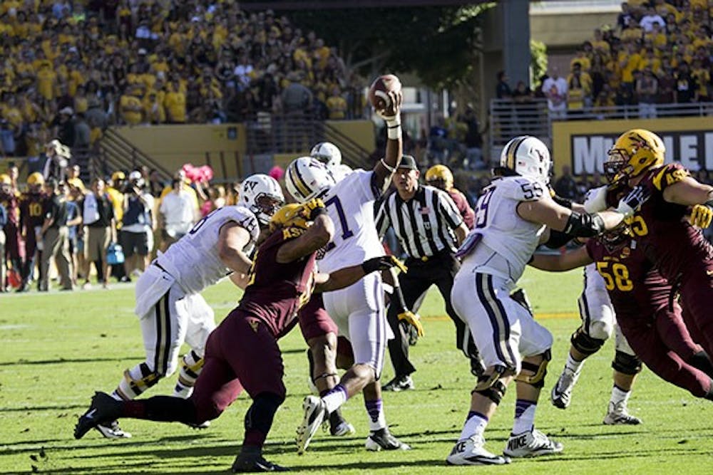 Redshirt junior defensive end Carl Bradford tackles senior quarterback Keith Price this weekend at a home game in Tempe. ASU won 53-24. (Photo by Dominic Valente)