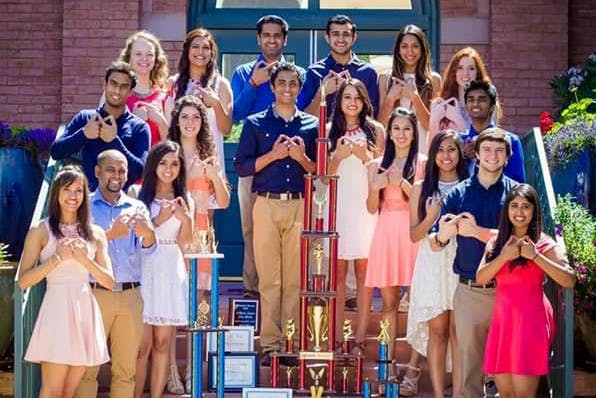 Andaaz, a Bollywood fusion dance team that incorporates various dance genres, poes for a photo with awards they have won. 
