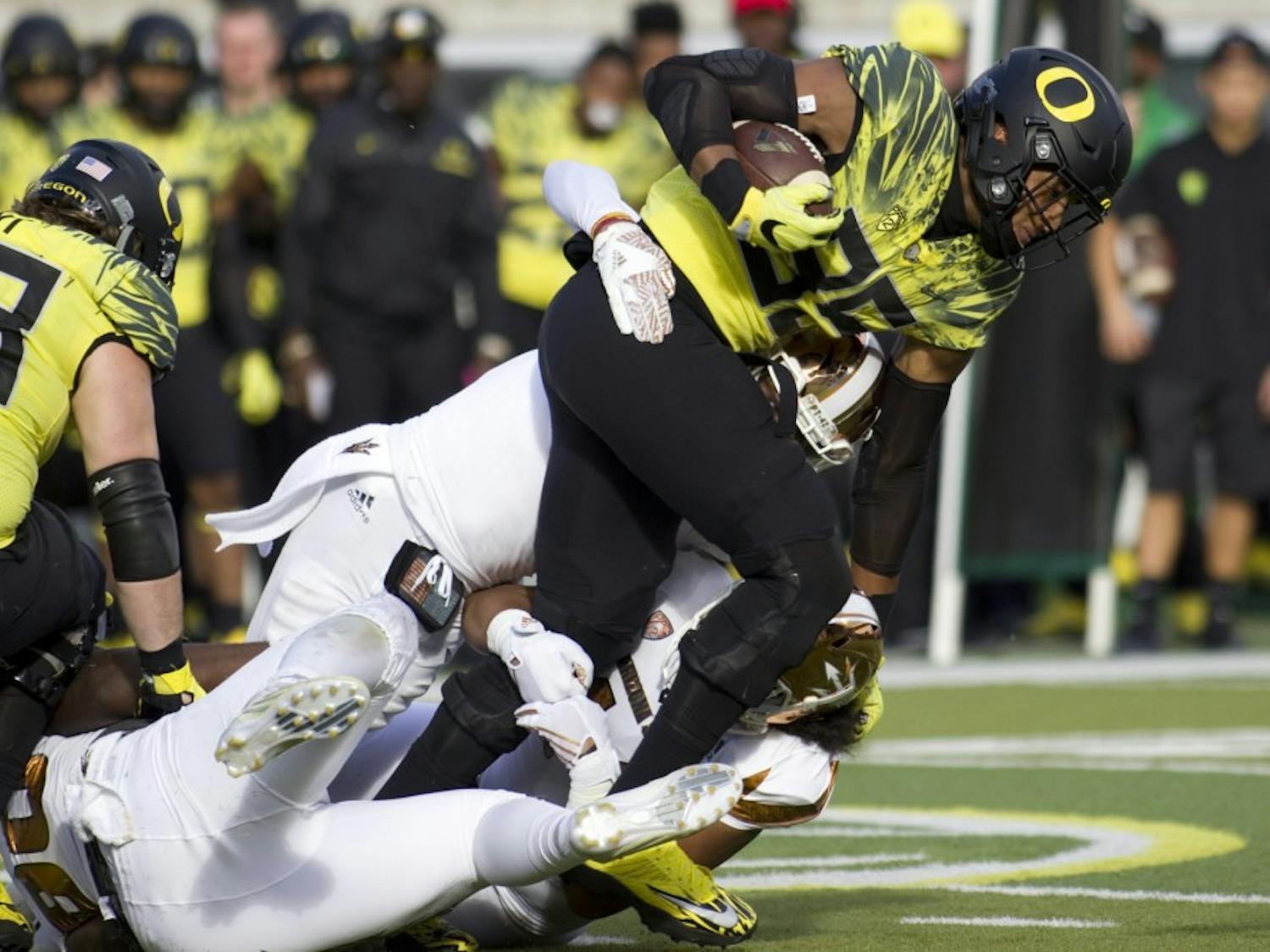 Oregon tight end Pharaoh Brown (85) gets tackled by two ASU defensive players in the first half of a game versus the Oregon Ducks in Autzen Stadium in Eugene, Oregon on Saturday, Oct. 29, 2016. 