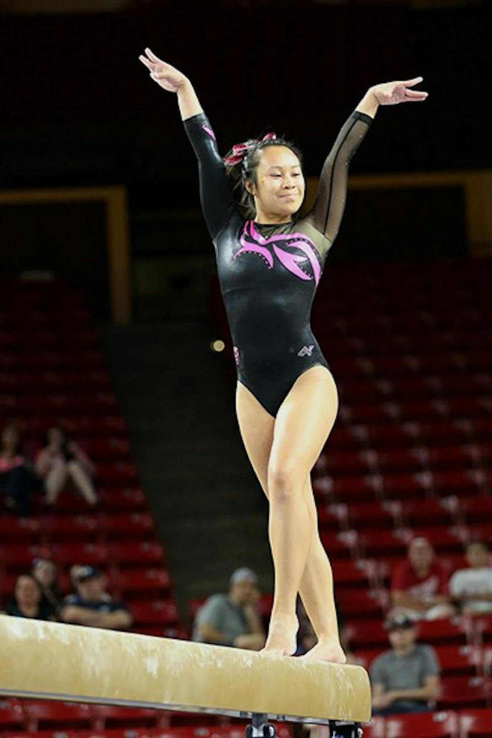Freshman Gilly Hogue strikes a pose during her beam routine at a home meet on Feb. 15. Gilly returned after having sat out the last two weeks due to back spasms. (Photo Courtesy of Arianna Grainey)
