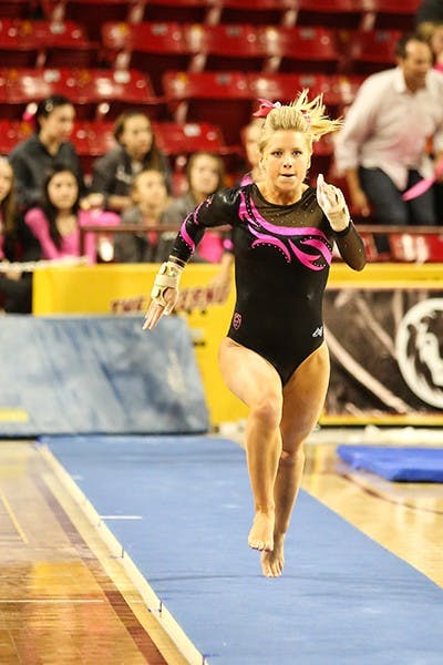 Sophomore Carissa Kraus runs down the vault runway during a home meet against BYU on Feb. 15. (Photo by Arianna Grainey)