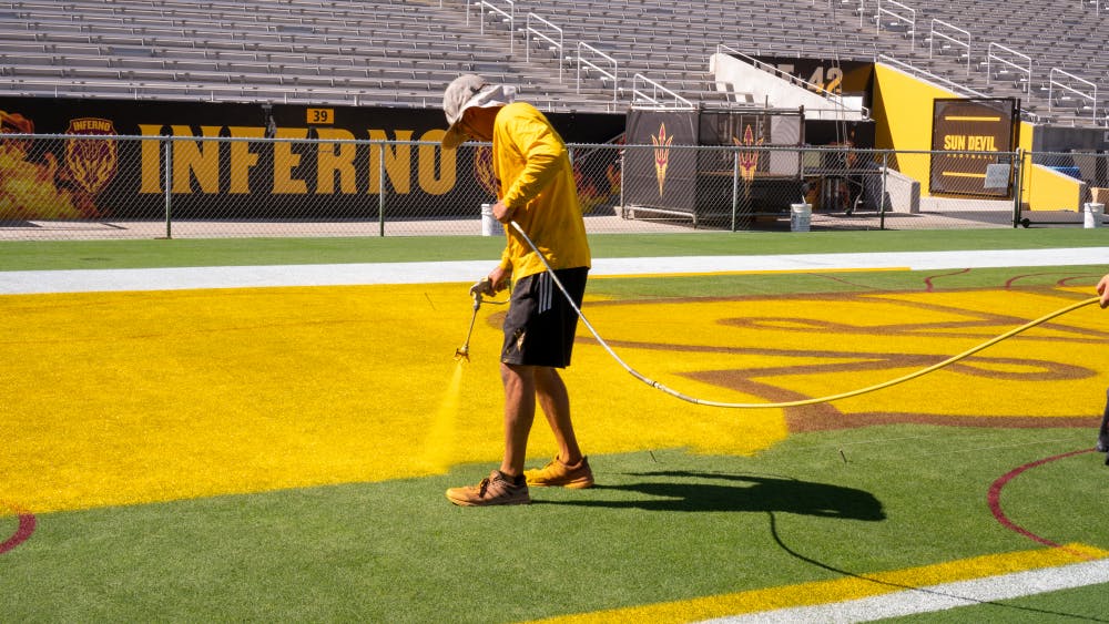 ASU groundskeeper painting endzone