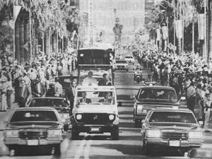 In this State Press file photo, rows of people line Central Avenue in Phoenix to glimpse Pope John Paul II in the “popemobile” en route to St. Mary’s Basilica on Tuesday, Sept. 15, 1987. (Courtesy of The Arizona Republic)