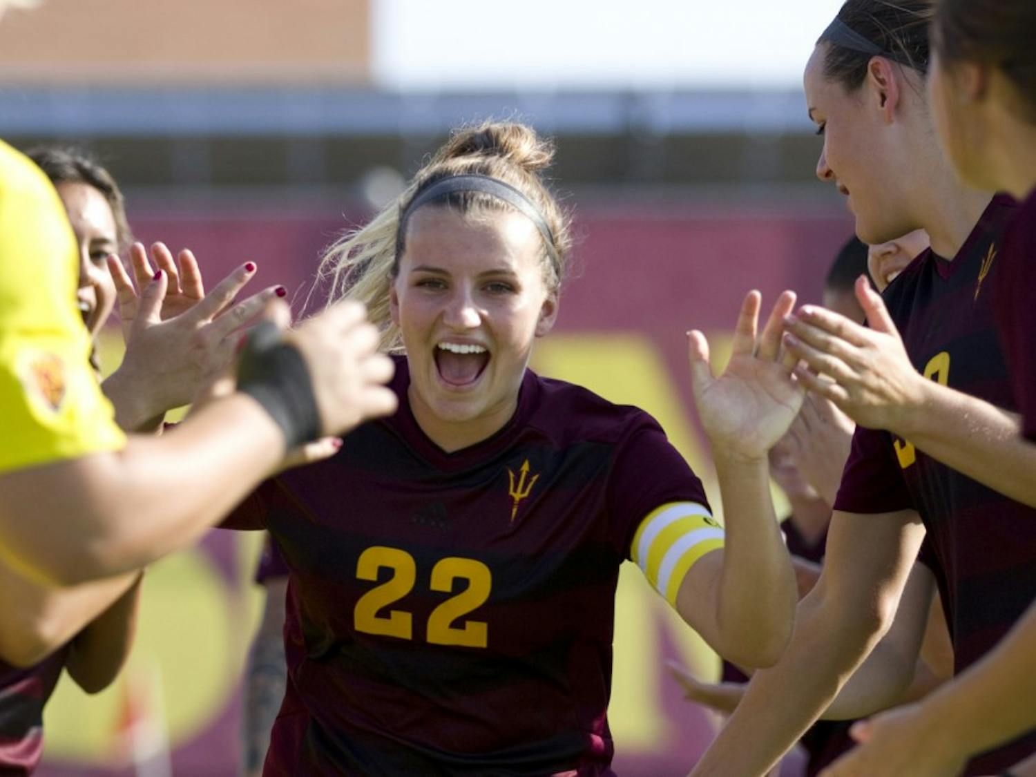 ASU junior defender Madison Stark runs through the tunnel of teammates during player introductions before a 2-0 win over Cal State Fullerton in Sun Devil Soccer Stadium in Tempe, Arizona, on Friday, Sept. 16, 2016.