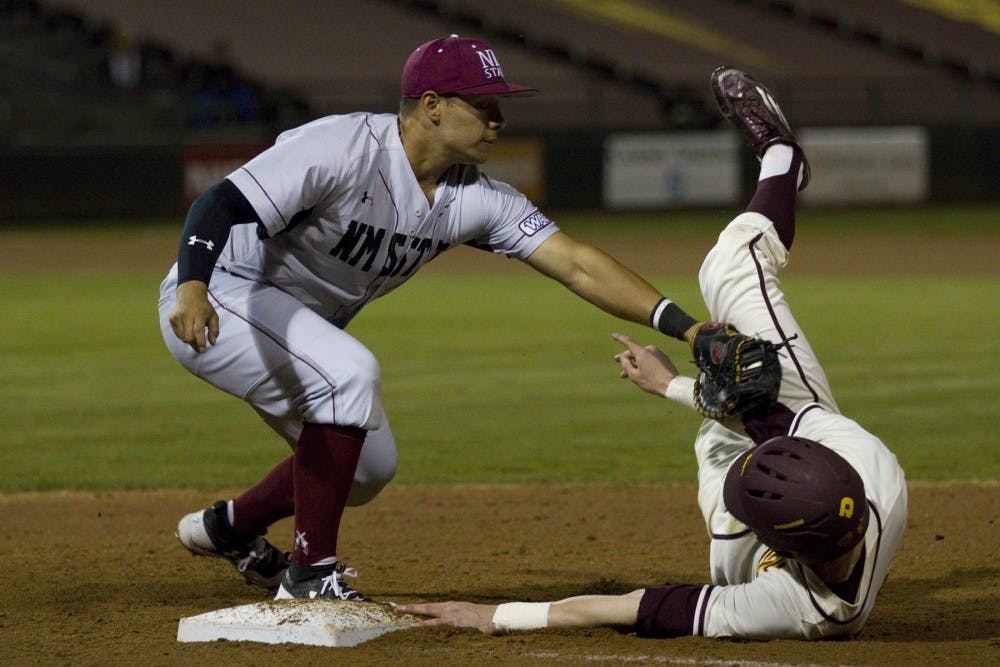ASU junior outfielder Ryan Lillard (5) dives back to first base on a pickoff attempt during a baseball game versus the New Mexico State Aggies at Phoenix Municipal Stadium in Phoenix, Arizona on Tuesday, Feb. 28, 2017. ASU won 12-5. 