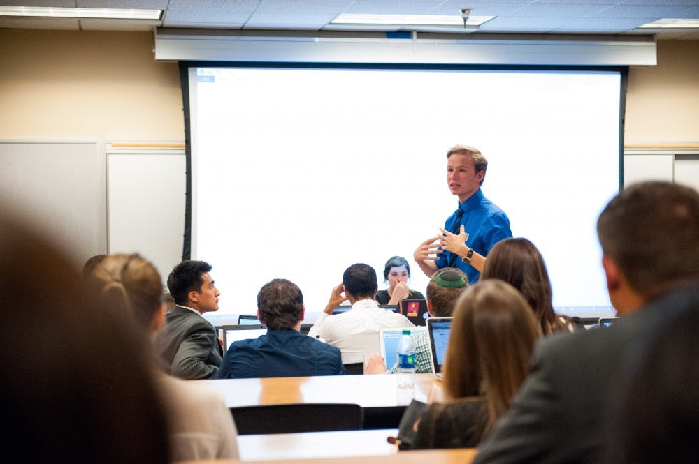 Tempe Undergraduate Student Government Sen. Daniel Martin explains Senate Bill 55 at a Senate meeting, Tuesday, Oct. 21, 2014. The bill, which passed in a floor vote, aims to restructure USG's bylaws to make them more easily understandable. (Photo by Ben Moffat)