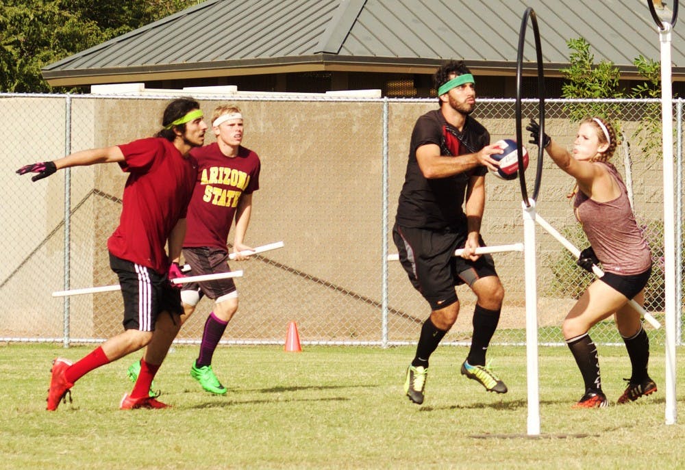 Paulo Avelar (left), Jacob Lawson, Alex Browne and Tori Kaiser compete in the Tempe Brawl Quidditch tournament on Oct. 17, 2015 in Tempe.