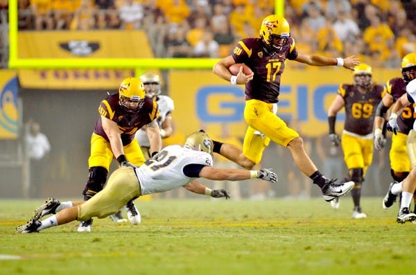 TIGER WATCHING: ASU junior quarterback Brock Osweiler evades a tackle as he runs up field during the Sun Devils’ demolition of UC Davis on Sept. 1. Osweiler said on Monday the intensity of Mizzou’s defensive line would be the Sun Devils’ biggest challenge. (Photo by Aaron Lavinsky)