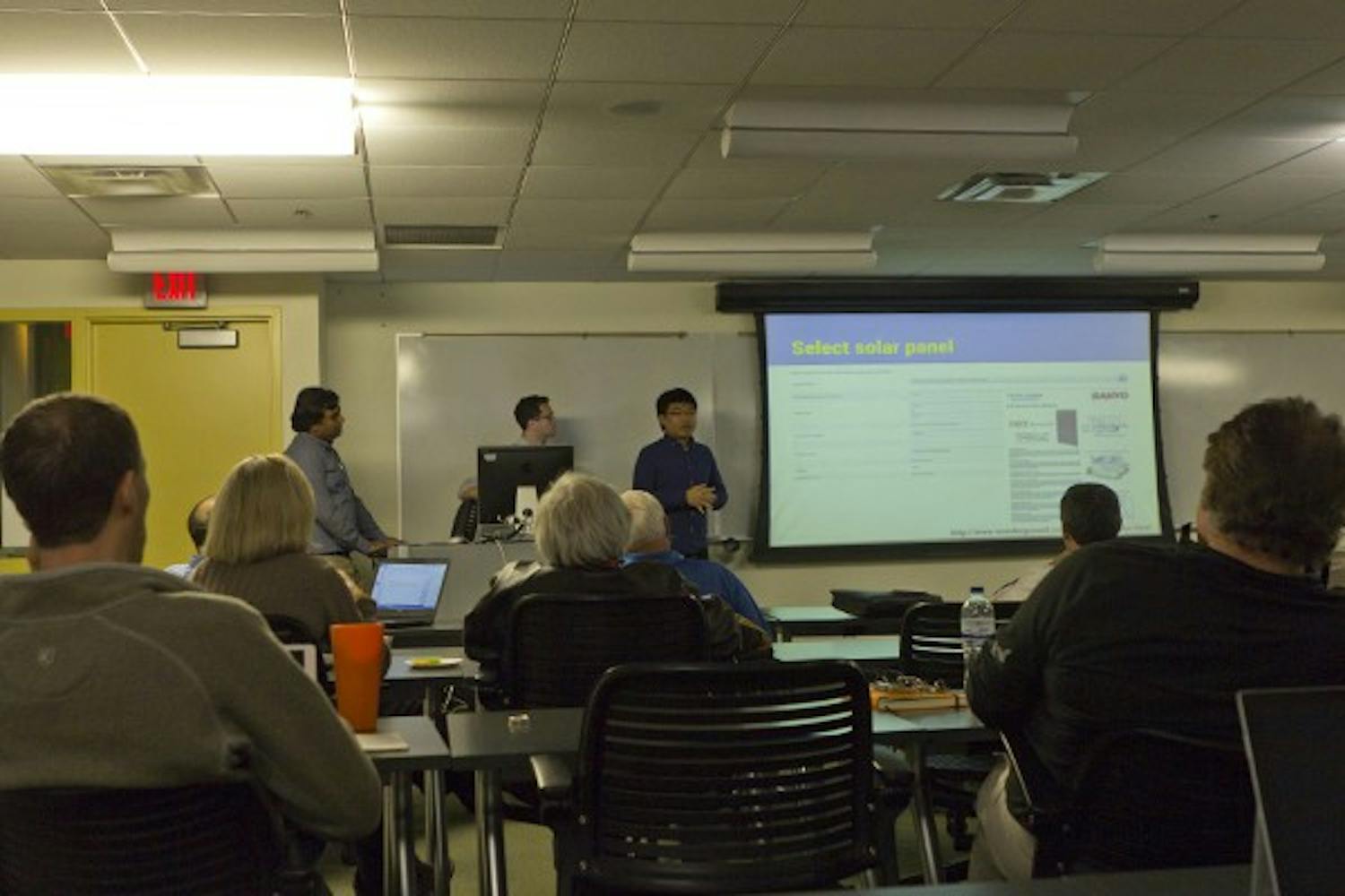 Graduate students showcase their presentations to a large group of people at the School of Sustainability on Dec. 1, 2014. These students present their proposals for Phoenix's Resource Innovation and Solutions Network (RISN).? (Photo by Emily Johnson)