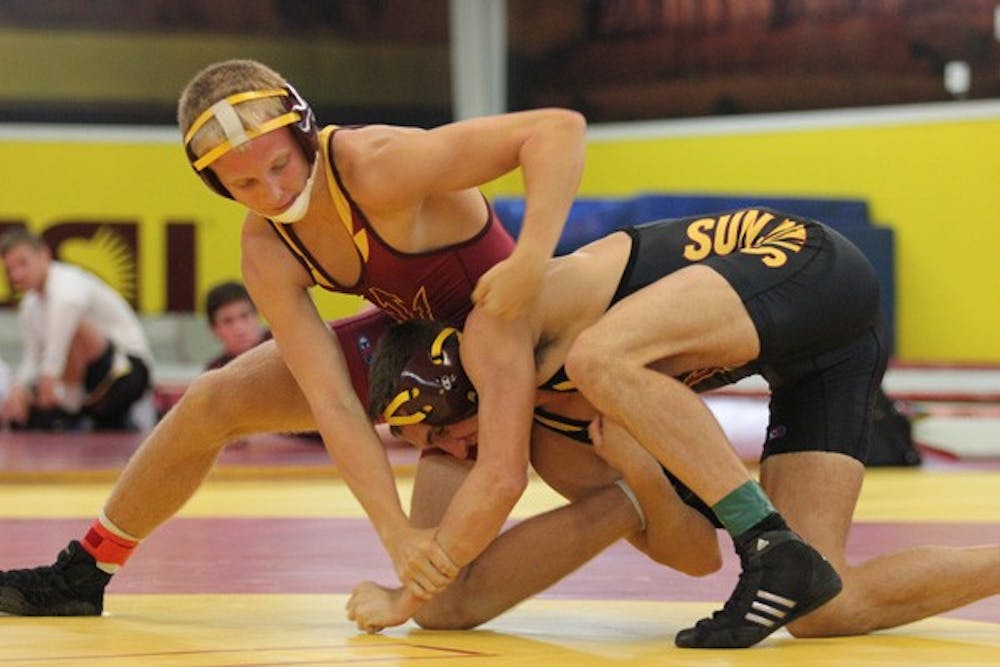 Two ASU wrestlers compete against each other in a match between teammates. The wrestling team were handed their sixth straight loss to Oregon State on Feb.  9. (Photo by Kyle Newman)