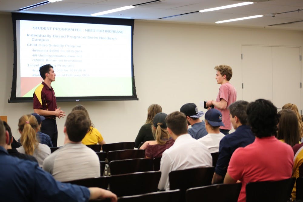 Isaac Miller and freshman Kyle Cloud ask questions to each other in front of the crowd.