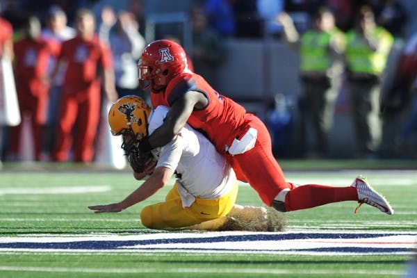 Redshirt senior quarterback Taylor Kelly gets sacked during the 2nd half of the game against UA on Friday, Nov. 28, 2014. UA defeated ASU 42-35 in Tucson. (Photo by Andrew Ybanez)