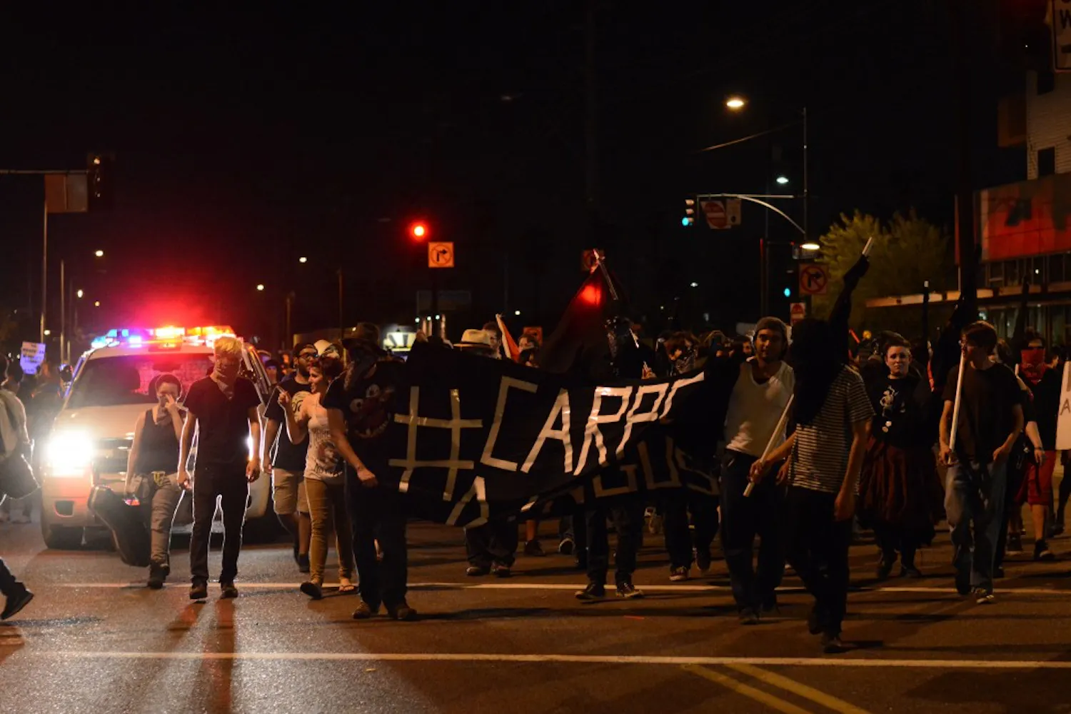 Demonstrators march down Roosevelt Street as part of a protest against police brutality Friday. (Photo by Jonathan Williams)